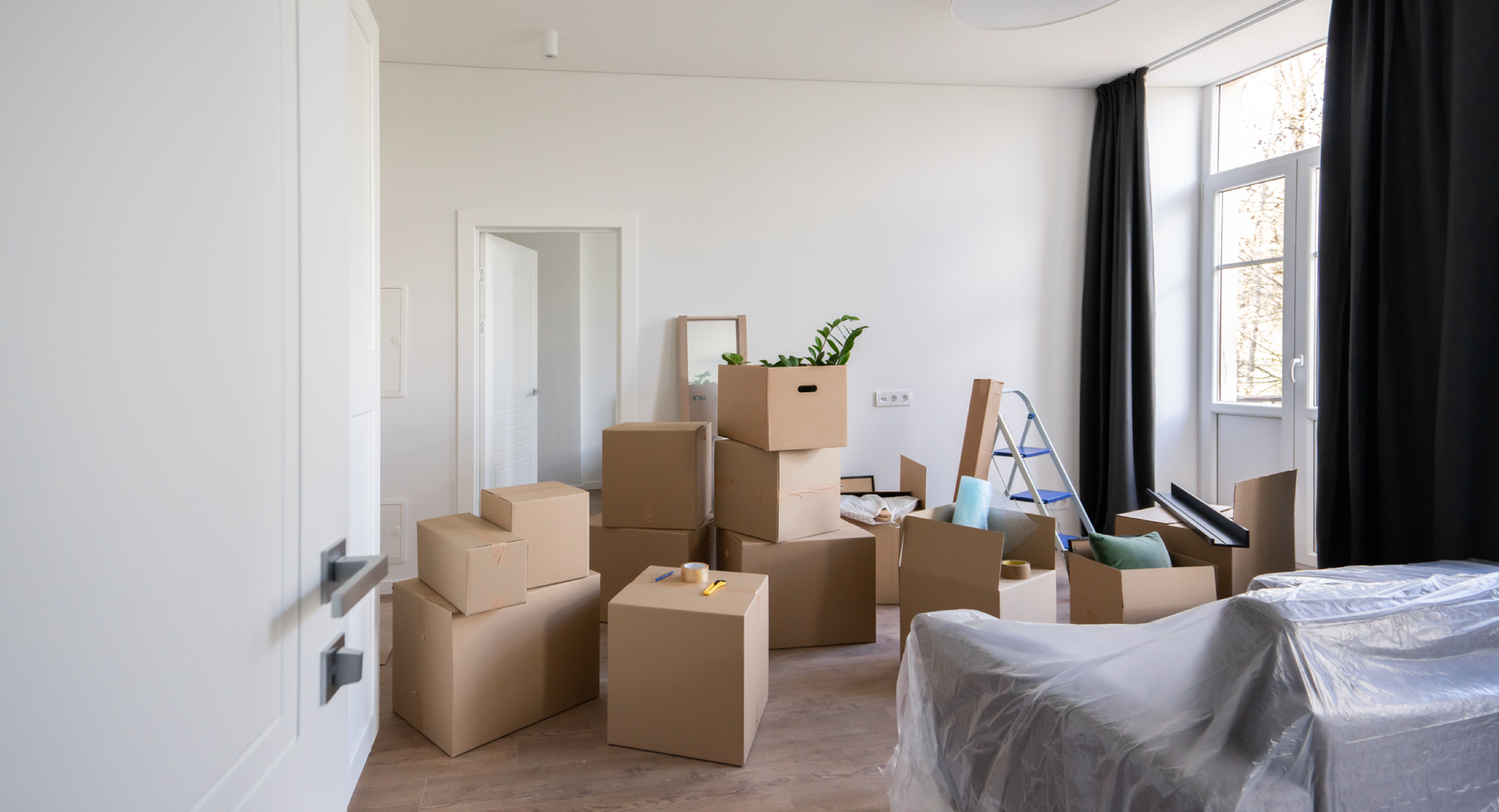 Moving Boxes Piled up in a New Apartment - Toggle Renters Insurance