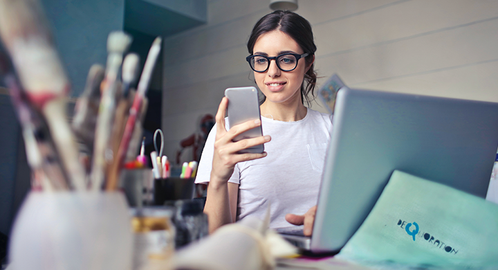  Woman on Her Phone at a Desk - Toggle Renters Insurance 