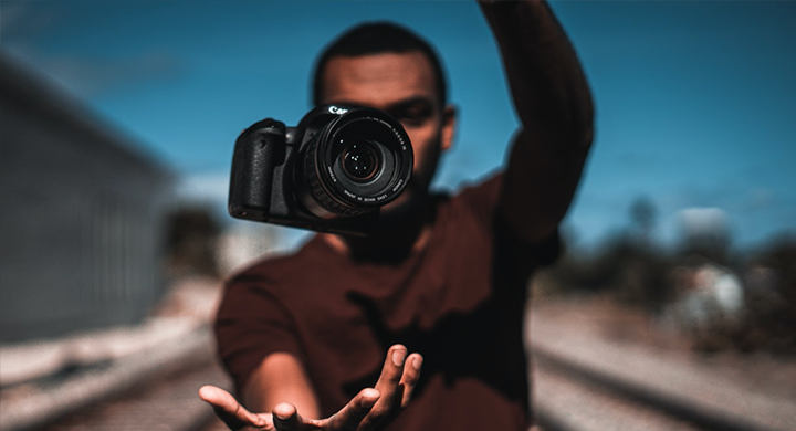 Man Tossing a Camera in the Air - Toggle Insurance