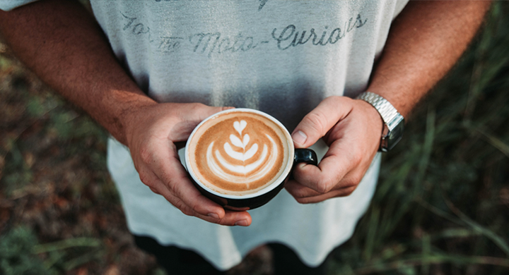 Person Holding a Coffee with Foam Art Design - Toggle Renters Insurance