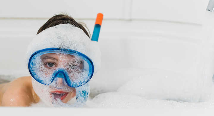 Child Wearing a Snorkel in a Bubble Bath  