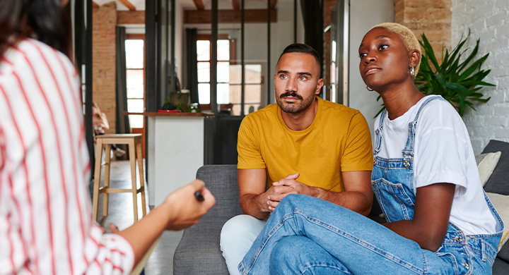 People Talking while Seated on a Couch