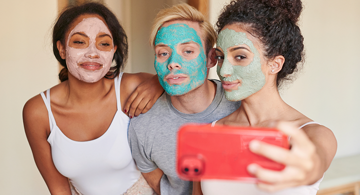 Three People Taking a Photo in Cosmetic Facial Masks