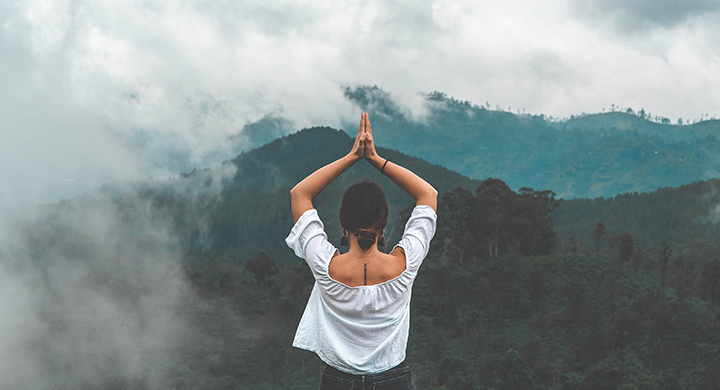 Woman Doing Yoga on Mountain - Toggle Insurance 