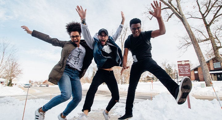 Three People Jumping and Smiling 