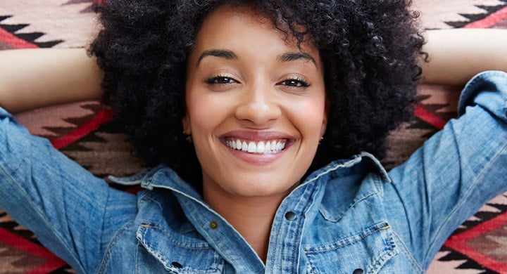 Woman Laying on her Back Smiling - Toggle Renters Insurance