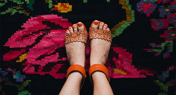 Person’s Feet on Decorative Rug - Toggle Renters Insurance