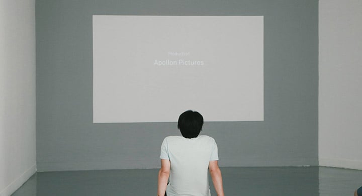 Person Looking at Projection that Says, “Production Apollon Pictures” 