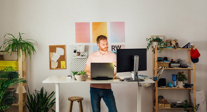 Man Working at Standing Desk - Toggle Insurance