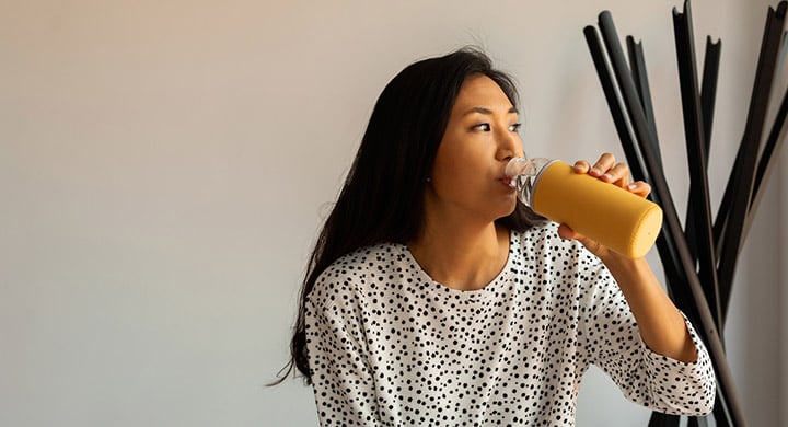 Woman Drinking from Reusable Water Bottle - Toggle Renter’s Insurance