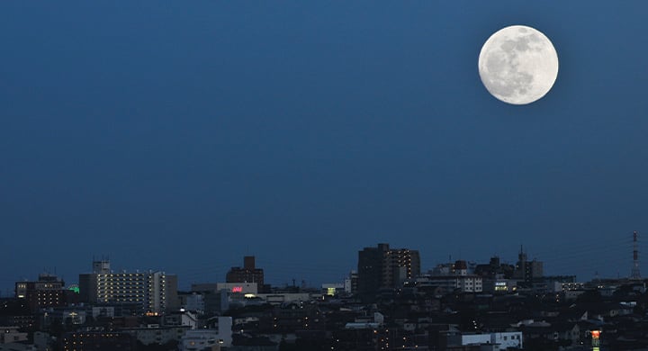 Full moon over a cityscape